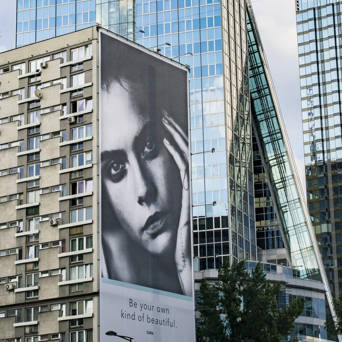 Giant black-and-white face billboard between apartment towers